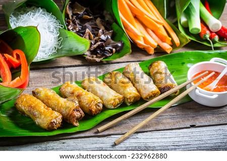 Fried spring rolls surrounded by ingredients