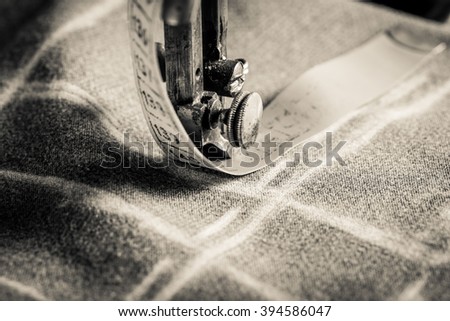Vintage tailor machine with scissors, cloth and threads