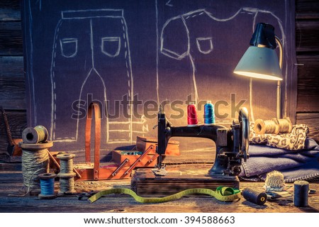 Old tailor workshop with sewing machine and cloth
