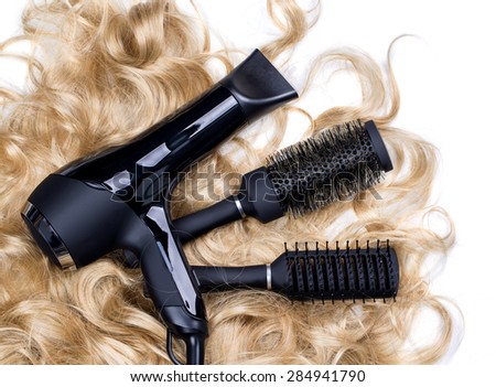 hairdressers tools on a background of the blond hair