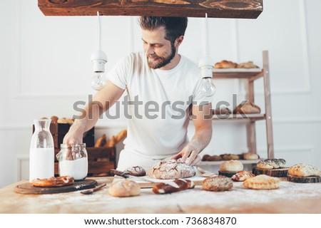 Baker with a variety of healthy and delicious freshly baked bread and pastry