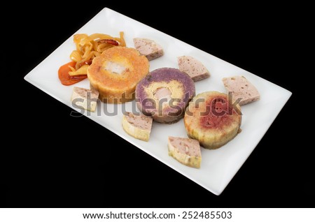Vietnamese assorted conical sticky rice cakes stuffed banana and red bean on black background