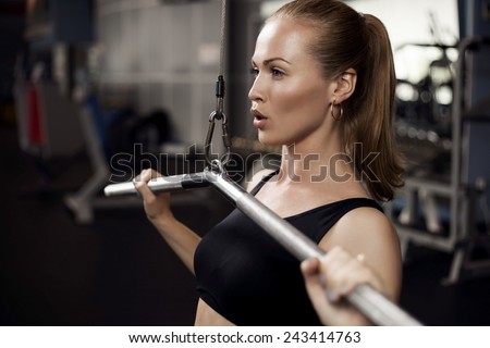beautiful muscular fit woman exercising building muscles