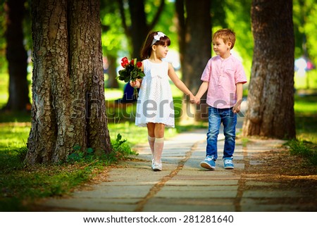 cute kid walking together in summer park