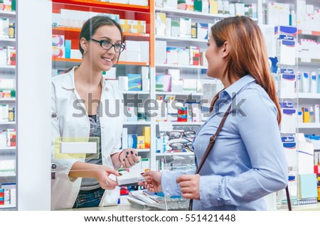 Pharmacist talking with a customer at the pharmacy desk