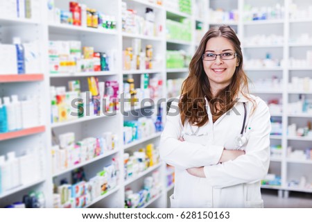 Pharmacist chemist woman standing in pharmacy - drugstore