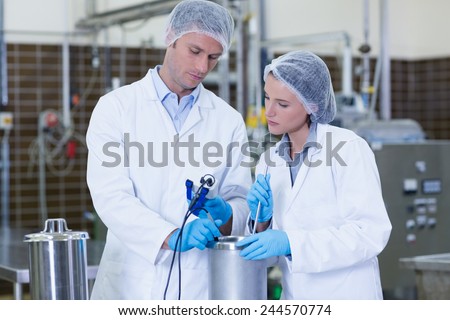 Focused biologist team working together in the factory