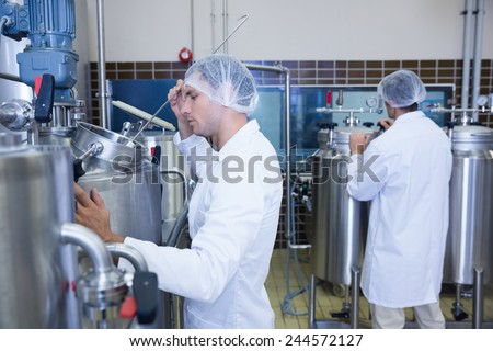 Scientists wearing lab coat and hair net in the factory