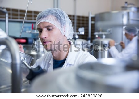 Close up of a man wearing a hair net in the factory