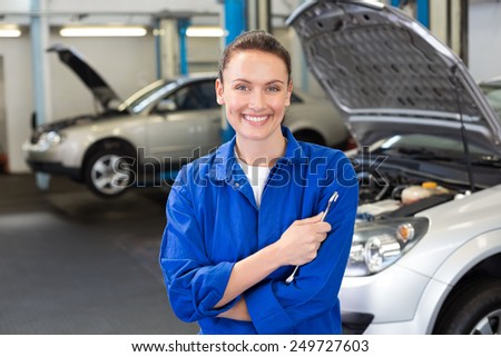 Smiling mechanic looking at camera at the repair garage