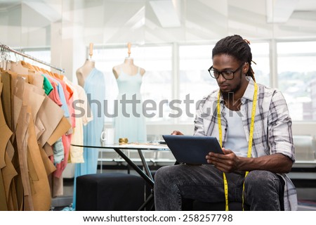 Male fashion designer using digital tablet