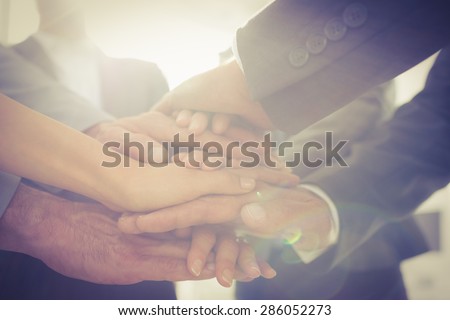 Business team standing hands together in the office