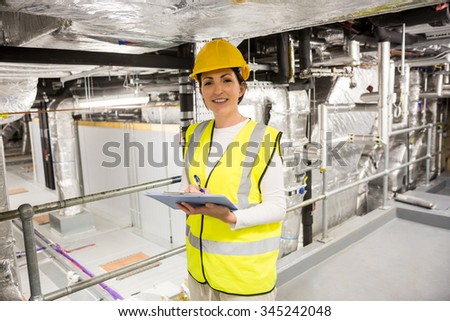 Engineer checking the temperature pipes in the control room