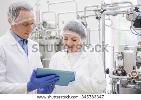 Scientists using tablet to control vats in the lab