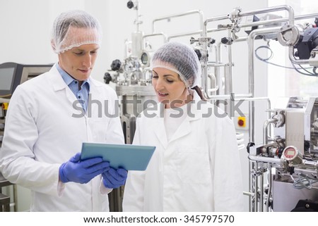 Pumps and taps on large vat in the lab
