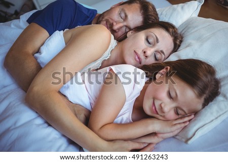 https://thumb1.shutterstock.com/display_pic_with_logo/76219/491263243/stock-photo-family-sleeping-on-bed-at-home-491263243.jpg