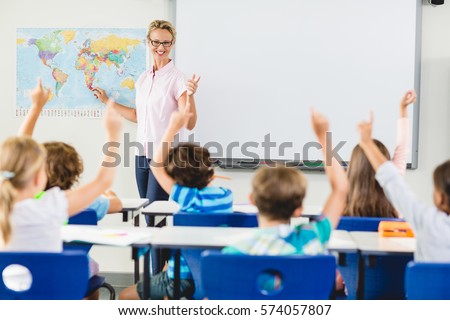 Teacher teaching kids in classroom at school