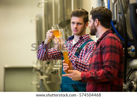 Brewers testing beer at brewery factory