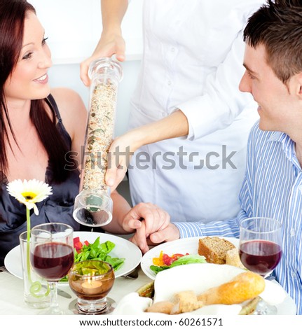 https://thumb1.shutterstock.com/display_pic_with_logo/76219/76219,1283445768,14/stock-photo-merry-young-couple-dining-at-the-restaurant-with-waiter-putting-pepper-in-their-plate-60261571.jpg