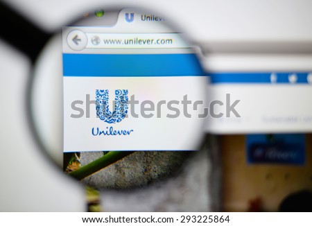 LISBON, PORTUGAL - June 6, 2015. Photo of unilever homepage on a monitor screen through a magnifying glass.