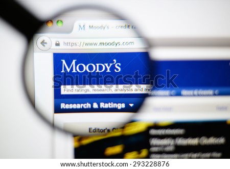 LISBON, PORTUGAL - June 6, 2015. Photo of Moody's  homepage on a monitor screen through a magnifying glass.