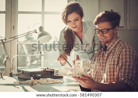 Confident team of engineers working together in a architect studio