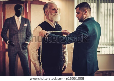 Tailor measuring client for custom made garment