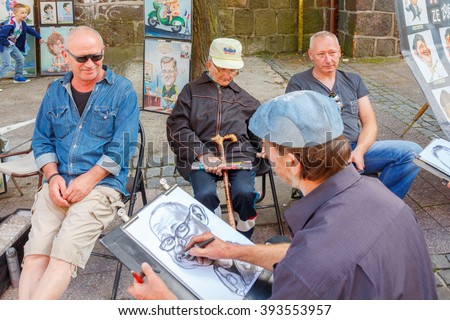 Sopot, Poland - August 1, 2015 in Sopot is one of the most popular tourist resorts in Poland. Street artists and cartoonists in the street of Monte Cassino in Sopot.