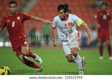 BANGKOK THAILAND-NOVEMBER 30:Nguyen Minh Duc of Vietnam ( white) in action during the AFF Suzuki Cup between Vietnam and Thailand at Rajamangala stadium on Nov30, 2012 in Bangkok,Thailand.