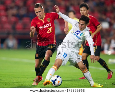 NONTHABURI-THAILAND FEB 8: Nguyen Quoc Long #22 (white)of Hanoi T&T in action during the AFC Champions League 2014 between Muangthong utd and Hanoi T&T at SCG Stadium on February 8, 2014 in Thailand