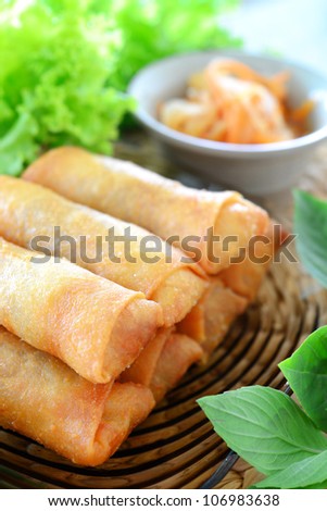 crispy spring rolls on clear dish with vegetable