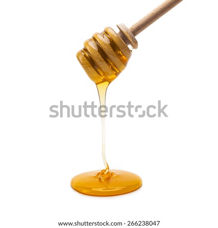 honey runs a honey dipper down isolated on white