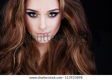 Glamorous Woman with Long Permed Hair and Smokey Eyes Party Makeup