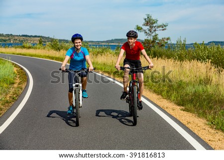 Healthy lifestyle - teenage girl and boy cycling