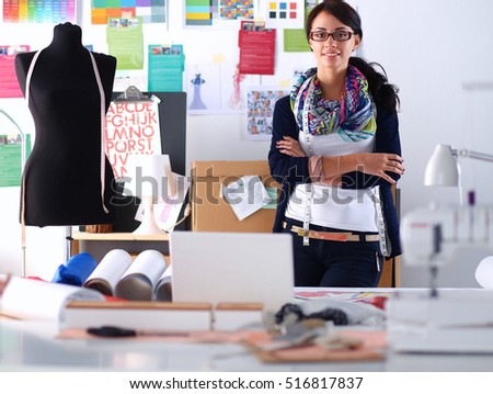 Beautiful fashion woman designer standing in studio