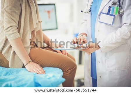 Doctor and patient discussing something while sitting at the table . Medicine and health care concept. Doctor and patient