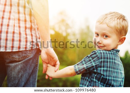 Father and son holding hand in hand