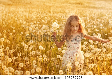 little girl with dandelions