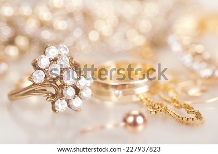 Gold jewelry with diamonds with reflection.