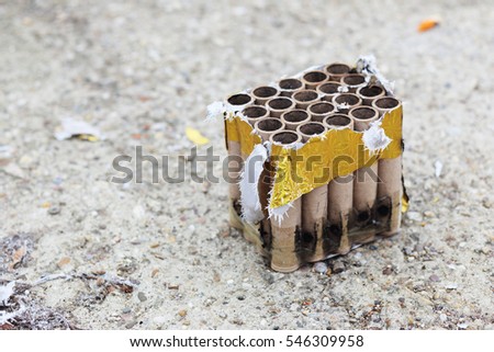 Used fireworks firecrackers lying on snow after exploding in celebration.