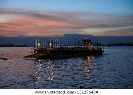 VINH LONG, VIETNAM - MARCH 6: Evening ferry crosses the Mekong river on March 6, 2009 from B�©n Tre to Vinh Long. Mekong river runs from the Tibetan Plateau through six Asian countries.