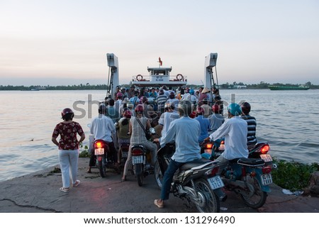 VINH LONG, VIETNAM - MARCH 6: Crowd of biker try to access a ferry across Mekong river on March 6, 2009 in Vinh Long. Mekong river runs from the Tibetan Plateau through six Asian countries.