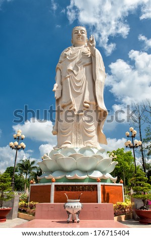Buddha statue in the garden of the famous Vinh Trang Pagoda at My Tho City, Vietnam.