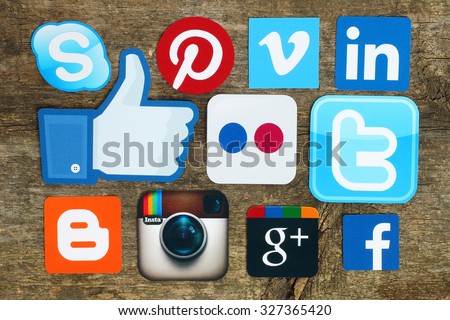 Kiev, Ukraine - April 15, 2015:Collection of popular social media logos printed on paper:Facebook, Twitter, Google Plus, Instagram, Skype, Pinterest and Blogger on old wooden background