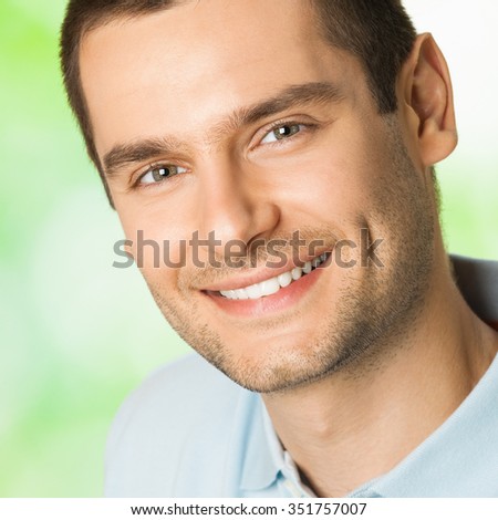 Portrait of handsome young attractive smiling man, outdoor