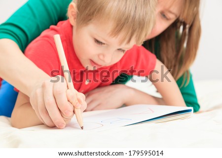hands of mother and child writing letters, early education