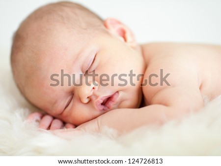 adorable baby sleeping on stomach