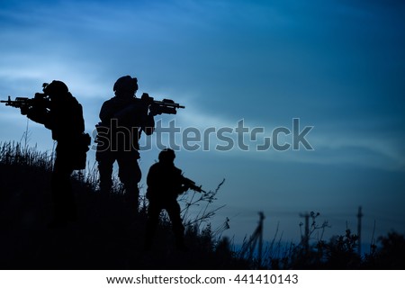 Silhouette of military soldier or officer with weapons at night. shot, holding gun, blue colorful sky, background