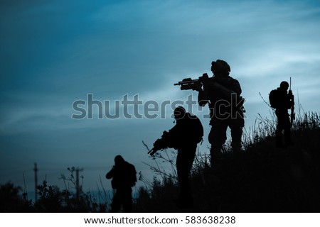 Silhouette of military soldier or officer with weapons at night. shot, holding gun, blue colorful sky, background