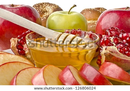 Still life closeup - challah, apples, pomegranate and bowl of honey, isolated over white. Illustration of Rosh Hashanah (jewish new year) or Savior of the Apple Feast Day